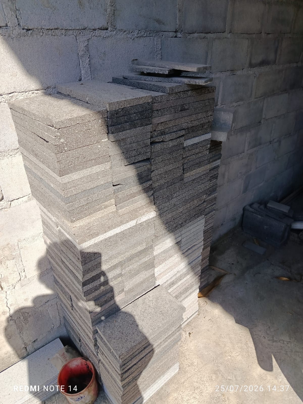 Stacks of rectangular Merapi lava stone tiles after cutting