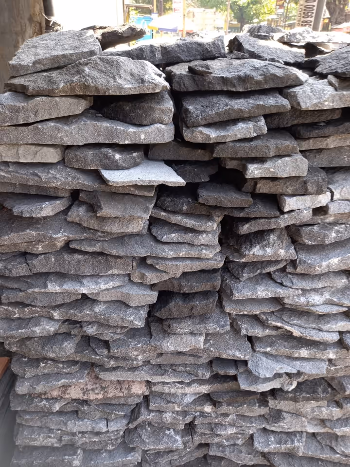 Thin irregular lava stone pieces stacked before final shaping